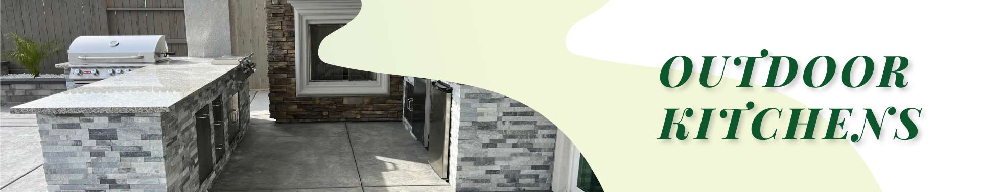 Professional outdoor culinary space design with a large built-in gas grill, premium stone veneer cabinetry, and a spacious granite prep station.